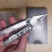 hand holding the leatherman arc multi-tool with the pliers out