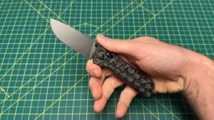 Holding the Olight Oknife Rubato 4 knife