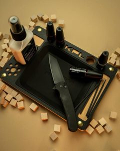 Knife maintenance tray with supplies for cleaning and oiling a pocket knife