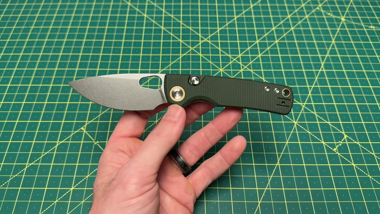 Vosteed Porcupine A2603 held horizontally, showing its full stonewashed blade and green Micarta handle