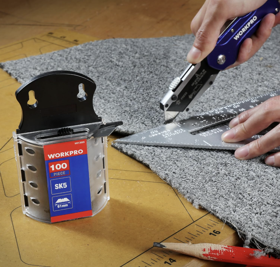 WORKPRO blade dispenser beside a utility knife cutting carpet